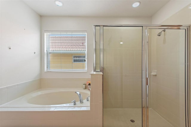 148 Miro Dr, Davenport, FL 33837 - bathroom featuring a bath, a shower stall, and recessed lighting