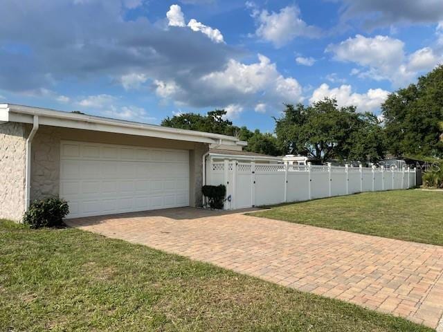 229 Doverwood Rd, Fern Park, FL 32730 - garage featuring decorative driveway and a gate
