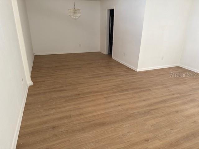 229 Doverwood Rd, Fern Park, FL 32730 - spare room featuring wood finished floors and a chandelier