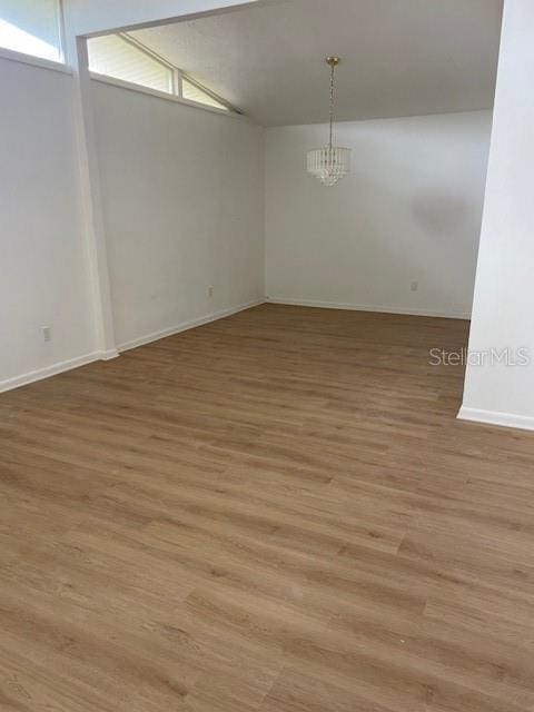229 Doverwood Rd, Fern Park, FL 32730 - spare room featuring light wood finished floors, a chandelier, plenty of natural light, and lofted ceiling