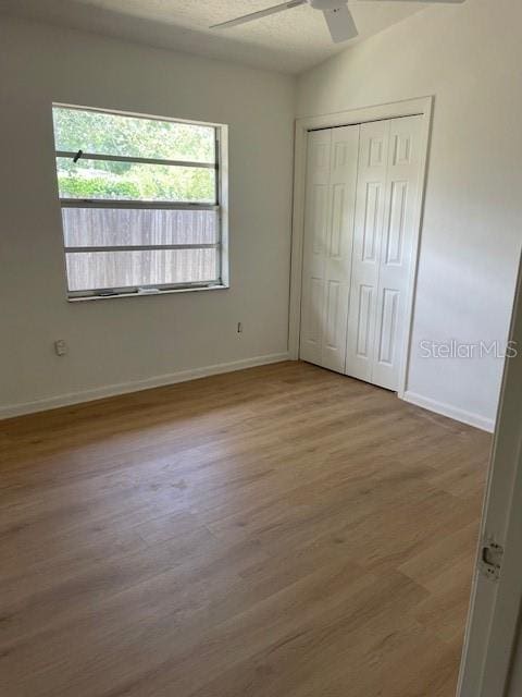 229 Doverwood Rd, Fern Park, FL 32730 - unfurnished bedroom featuring wood finished floors, a closet, and a ceiling fan