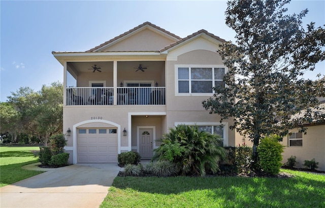 20130 Sunset Landing Ave, Groveland, FL 34736 - multi unit property featuring a balcony, a front lawn, stucco siding, ceiling fan, and concrete driveway