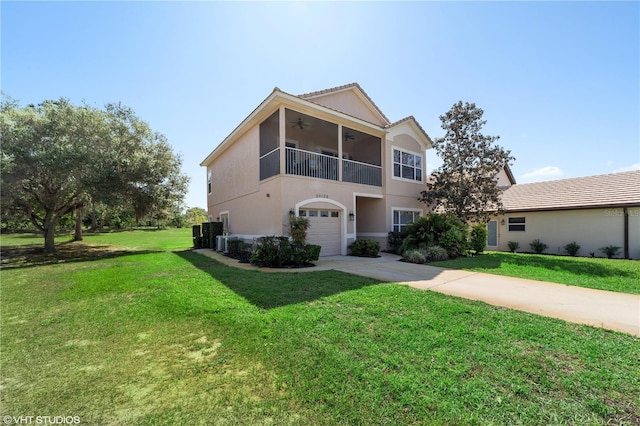 20130 Sunset Landing Ave, Groveland, FL 34736 - view of front of home featuring concrete driveway, a ceiling fan, a garage, stucco siding, and a front lawn