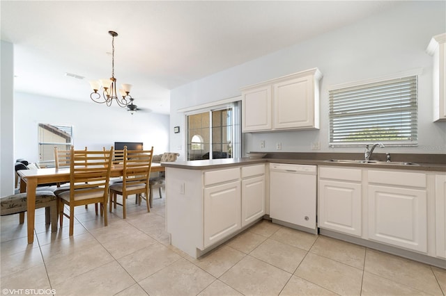20130 Sunset Landing Ave, Groveland, FL 34736 - kitchen with white dishwasher, a chandelier, a peninsula, and dark countertops