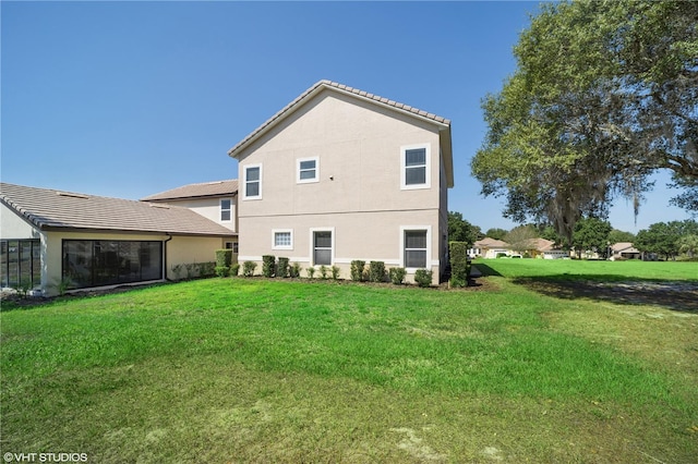 20130 Sunset Landing Ave, Groveland, FL 34736 - back of house featuring stucco siding, a lawn, and a tiled roof
