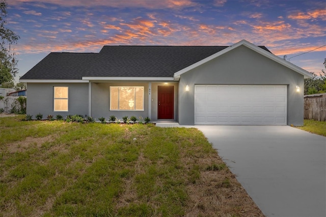 654 NE 130th Ct, Silver Springs, FL 34488 - view of front of property with driveway, roof with shingles, stucco siding, and a garage