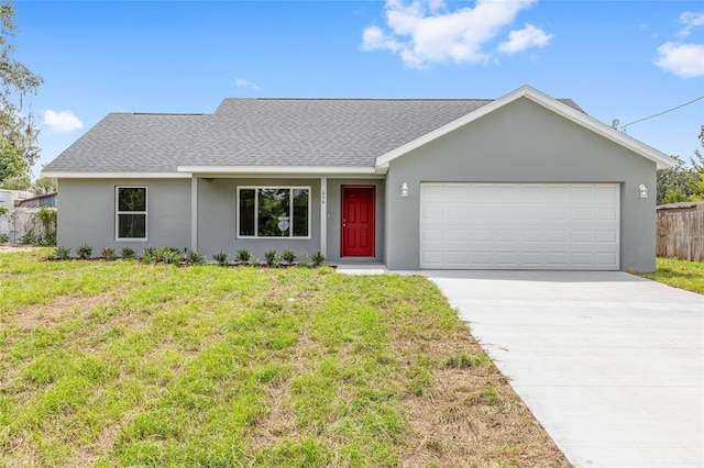 654 NE 130th Ct, Silver Springs, FL 34488 - view of front facade with roof with shingles, stucco siding, concrete driveway, and a garage