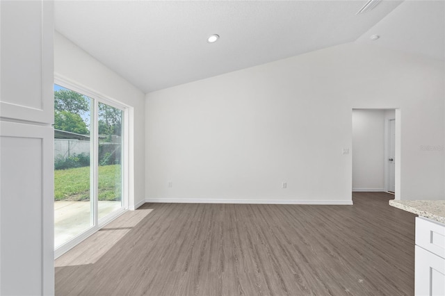 654 NE 130th Ct, Silver Springs, FL 34488 - spare room with vaulted ceiling and light wood-style floors