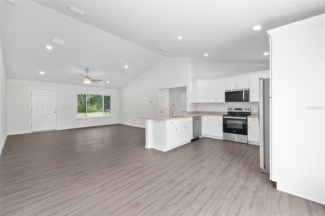 654 NE 130th Ct, Silver Springs, FL 34488 - kitchen with stainless steel appliances, a peninsula, open floor plan, white cabinetry, and ceiling fan