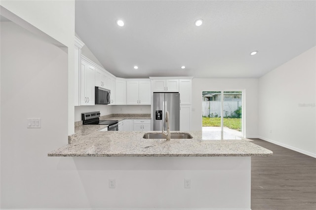 654 NE 130th Ct, Silver Springs, FL 34488 - kitchen featuring stainless steel appliances, white cabinets, light stone countertops, a peninsula, and recessed lighting