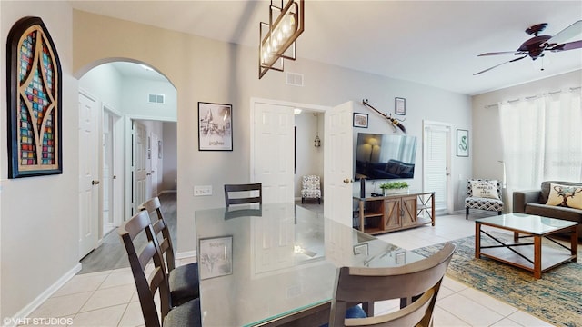 7675 Comrow St Unit 404, Kissimmee, FL 34747 - dining space featuring light tile patterned floors, a ceiling fan, and arched walkways