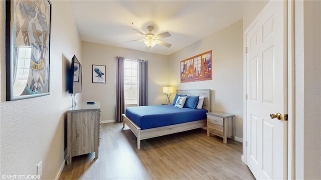 7675 Comrow St Unit 404, Kissimmee, FL 34747 - bedroom featuring light wood-style flooring and a ceiling fan