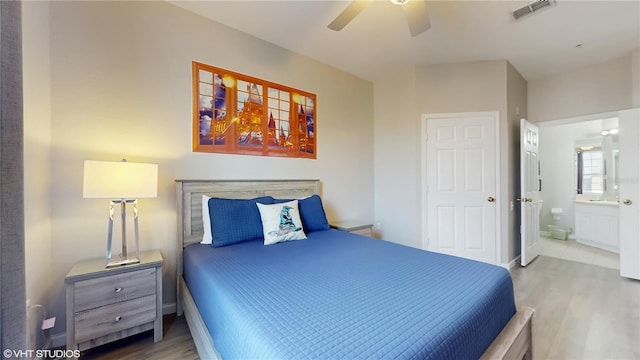 7675 Comrow St Unit 404, Kissimmee, FL 34747 - bedroom with wood finished floors, connected bathroom, and ceiling fan