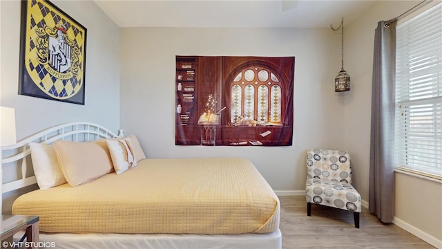 7675 Comrow St Unit 404, Kissimmee, FL 34747 - bedroom with multiple windows and wood finished floors