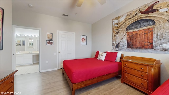7675 Comrow St Unit 404, Kissimmee, FL 34747 - bedroom with wood finished floors, ensuite bath, and ceiling fan