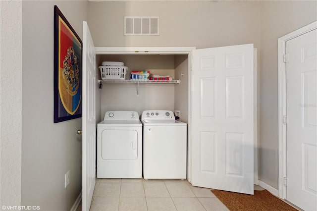 7675 Comrow St Unit 404, Kissimmee, FL 34747 - washroom with washing machine and clothes dryer and light tile patterned flooring