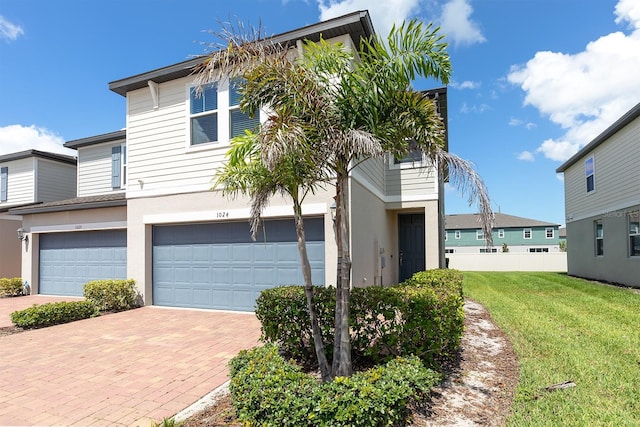 1024 Desert Candle Dr, Ocoee, FL 34761 - view of front facade with a garage, stucco siding, and decorative driveway