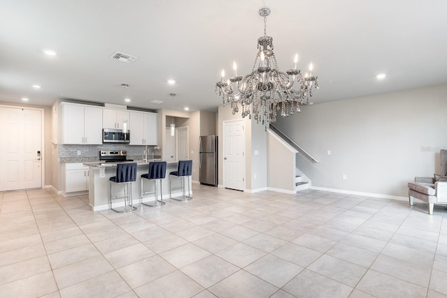 1024 Desert Candle Dr, Ocoee, FL 34761 - kitchen featuring stainless steel appliances, open floor plan, light tile patterned floors, and recessed lighting