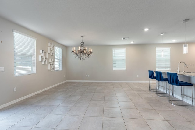 1024 Desert Candle Dr, Ocoee, FL 34761 - unfurnished dining area featuring plenty of natural light, light tile patterned flooring, a chandelier, and recessed lighting