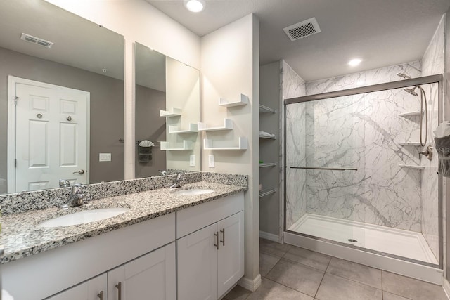 1024 Desert Candle Dr, Ocoee, FL 34761 - bathroom with double vanity, a marble finish shower, and tile patterned floors