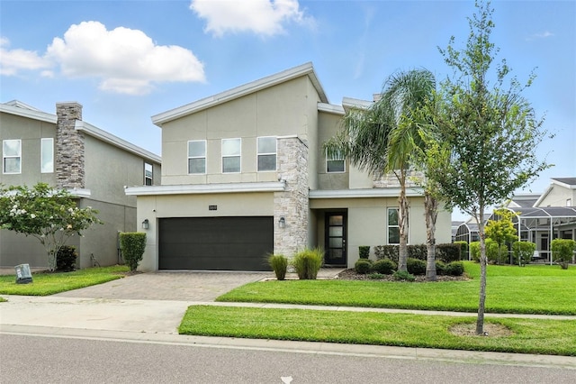 369 Ocean Course Ave, Davenport, FL 33896 - view of front of property with stucco siding, driveway, an attached garage, and a front yard