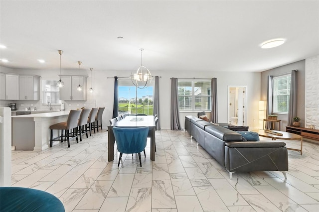 369 Ocean Course Ave, Davenport, FL 33896 - living room with light marble finish flooring, a chandelier, and recessed lighting