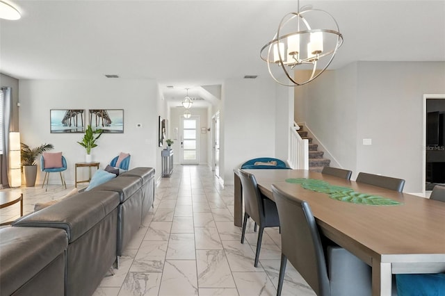 369 Ocean Course Ave, Davenport, FL 33896 - dining room featuring light marble finish flooring, stairs, and a chandelier