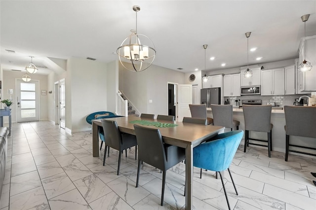369 Ocean Course Ave, Davenport, FL 33896 - dining space with light marble finish flooring, stairway, a chandelier, and recessed lighting