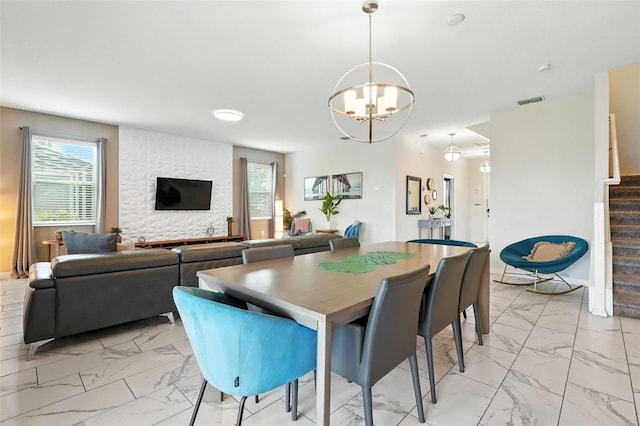 369 Ocean Course Ave, Davenport, FL 33896 - dining room featuring light marble finish floors, stairway, and a chandelier