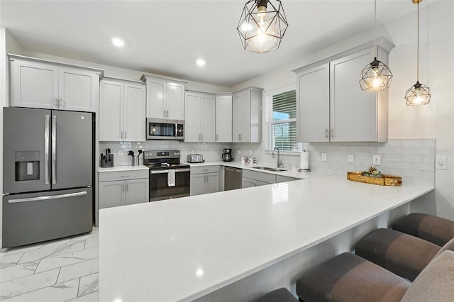 369 Ocean Course Ave, Davenport, FL 33896 - kitchen with stainless steel appliances, light countertops, a kitchen breakfast bar, a peninsula, and recessed lighting