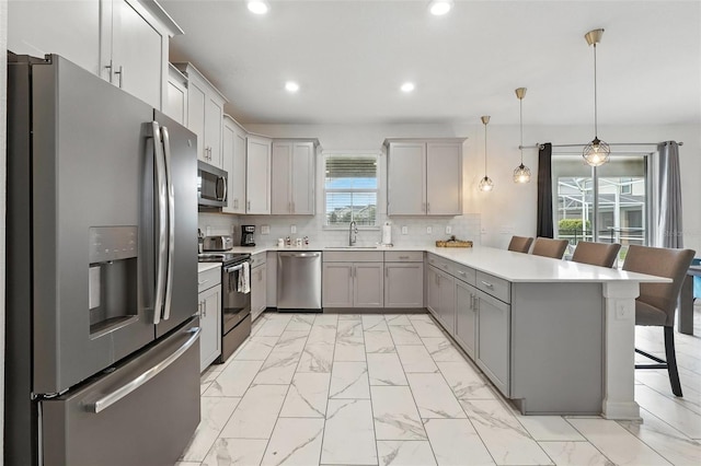 369 Ocean Course Ave, Davenport, FL 33896 - kitchen with appliances with stainless steel finishes, a peninsula, light marble finish flooring, gray cabinets, and recessed lighting