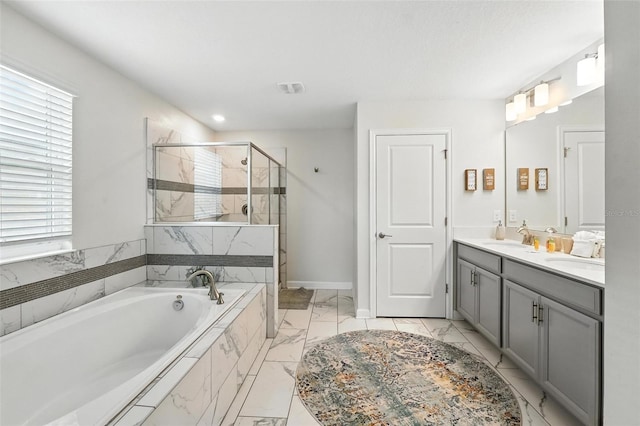 369 Ocean Course Ave, Davenport, FL 33896 - bathroom with marble finish flooring, a garden tub, a stall shower, healthy amount of natural light, and recessed lighting