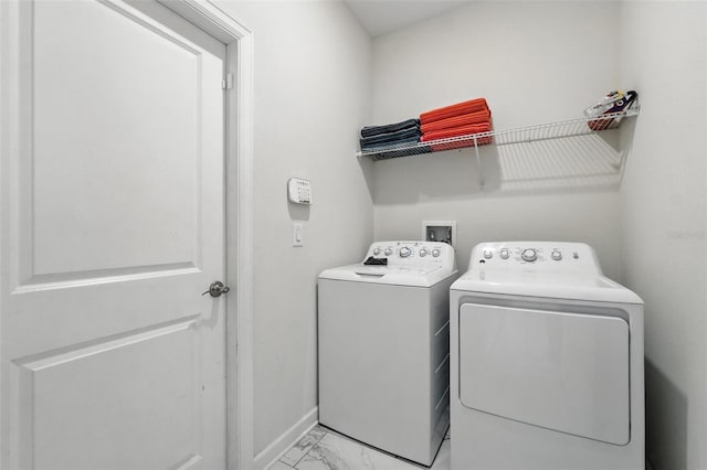 369 Ocean Course Ave, Davenport, FL 33896 - washroom featuring washer and clothes dryer and light marble finish floors