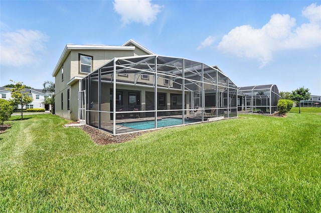 369 Ocean Course Ave, Davenport, FL 33896 - back of house featuring a lawn, stucco siding, an outdoor pool, and glass enclosure