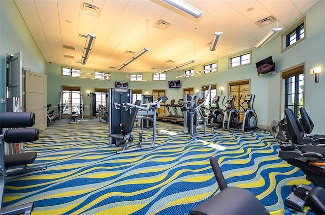 369 Ocean Course Ave, Davenport, FL 33896 - exercise room featuring carpet and a towering ceiling