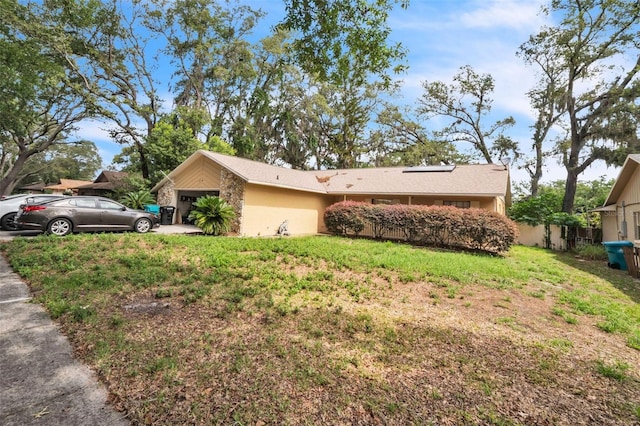 4799 Lighthouse Rd, Orlando, FL 32808 - view of property exterior with a garage, a yard, and stucco siding