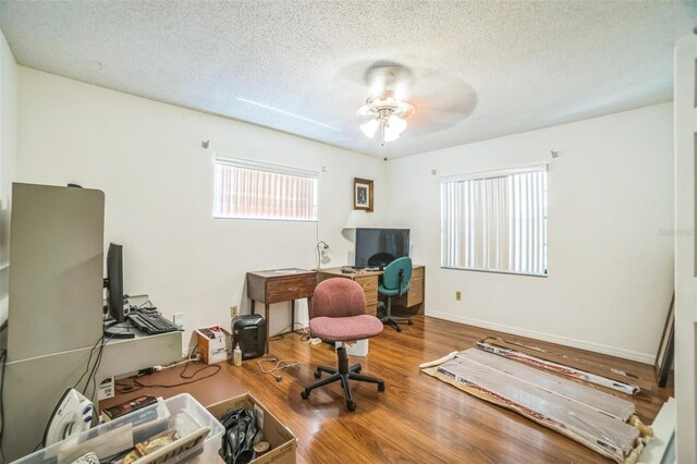 4799 Lighthouse Rd, Orlando, FL 32808 - home office featuring a textured ceiling, wood finished floors, and ceiling fan