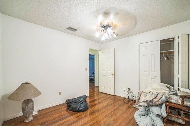 4799 Lighthouse Rd, Orlando, FL 32808 - bedroom with wood finished floors, a textured ceiling, a closet, and ceiling fan