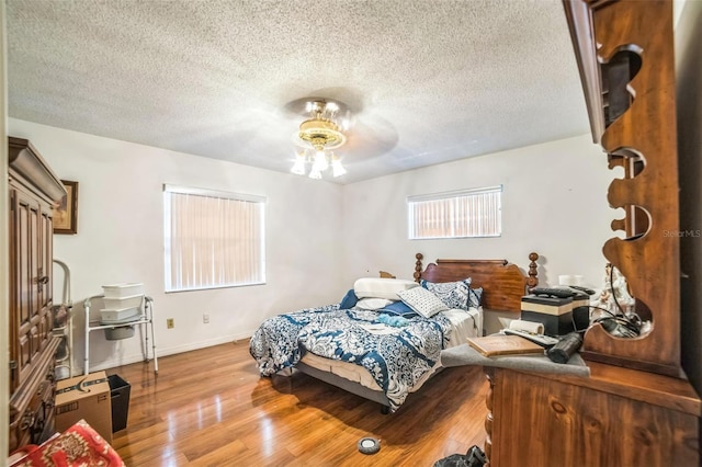4799 Lighthouse Rd, Orlando, FL 32808 - bedroom with wood finished floors, a textured ceiling, and a ceiling fan