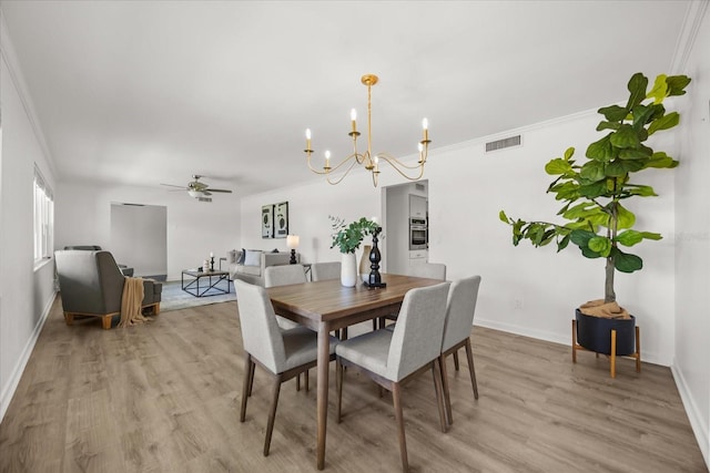 1505 N Lake Mirror Dr NW, Winter Haven, FL 33881 - dining space with a chandelier, light wood-style floors, ceiling fan, and ornamental molding