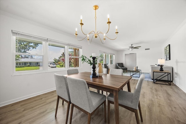 1505 N Lake Mirror Dr NW, Winter Haven, FL 33881 - dining room with a chandelier, ornamental molding, wood finished floors, and ceiling fan