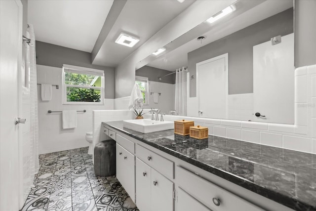 1505 N Lake Mirror Dr NW, Winter Haven, FL 33881 - full bathroom featuring vanity, a shower with shower curtain, a wainscoted wall, and tile walls