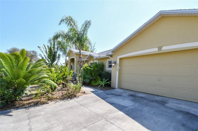 5769 E Price Blvd, North Port, FL 34288 - view of front facade featuring stucco siding, driveway, and an attached garage