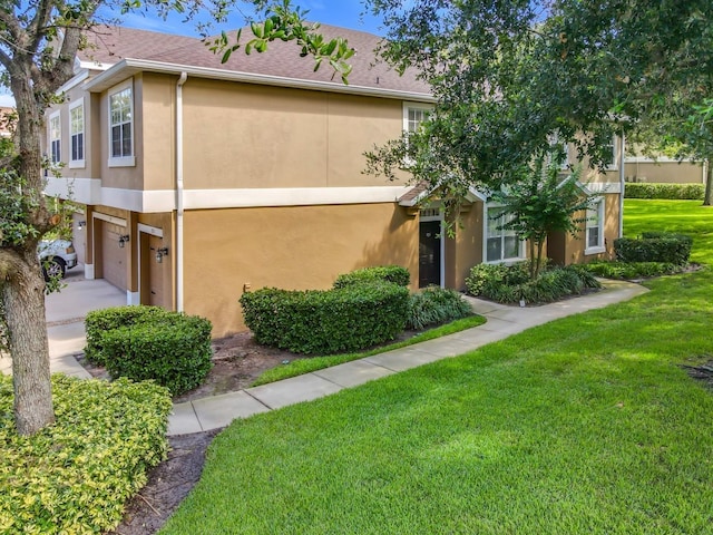 725 Ashworth Overlook Dr Unit C, Apopka, FL 32712 - view of property featuring stucco siding, a front lawn, and a garage