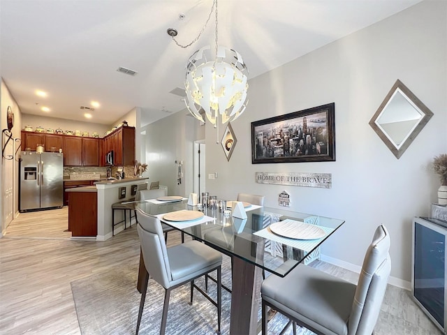 725 Ashworth Overlook Dr Unit C, Apopka, FL 32712 - dining area featuring a chandelier and light wood-type flooring