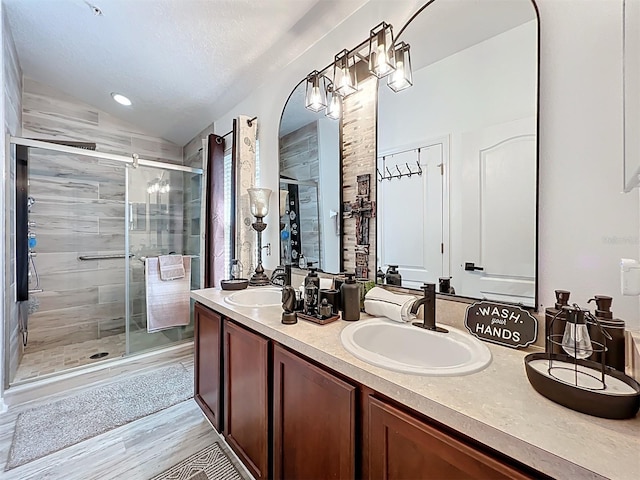 725 Ashworth Overlook Dr Unit C, Apopka, FL 32712 - full bath featuring double vanity, lofted ceiling, a stall shower, and wood finished floors