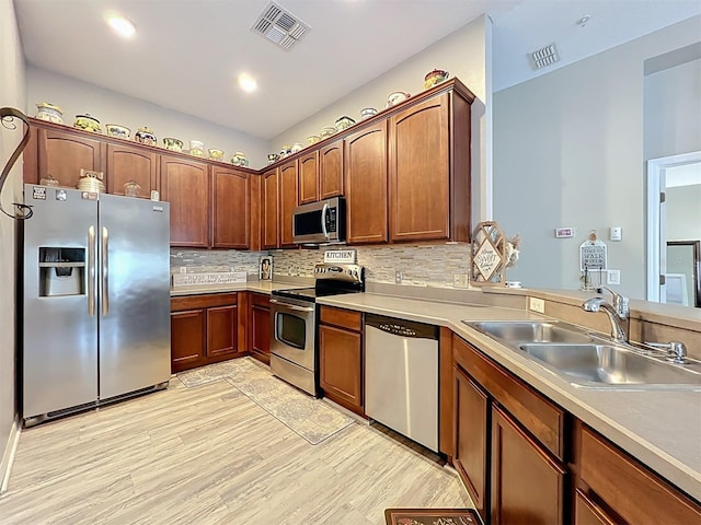 725 Ashworth Overlook Dr Unit C, Apopka, FL 32712 - kitchen featuring stainless steel appliances, light wood finished floors, tasteful backsplash, light countertops, and recessed lighting