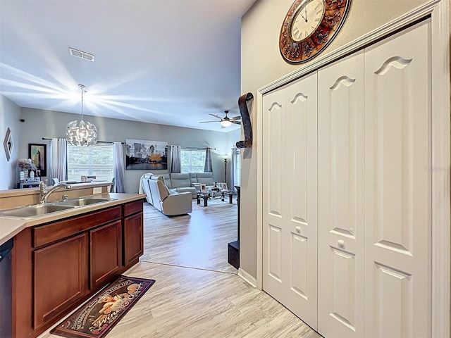725 Ashworth Overlook Dr Unit C, Apopka, FL 32712 - kitchen with hanging light fixtures, light wood finished floors, a chandelier, open floor plan, and ceiling fan