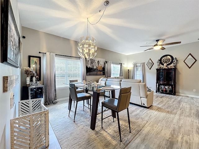 725 Ashworth Overlook Dr Unit C, Apopka, FL 32712 - dining area featuring a chandelier, light wood finished floors, and a ceiling fan