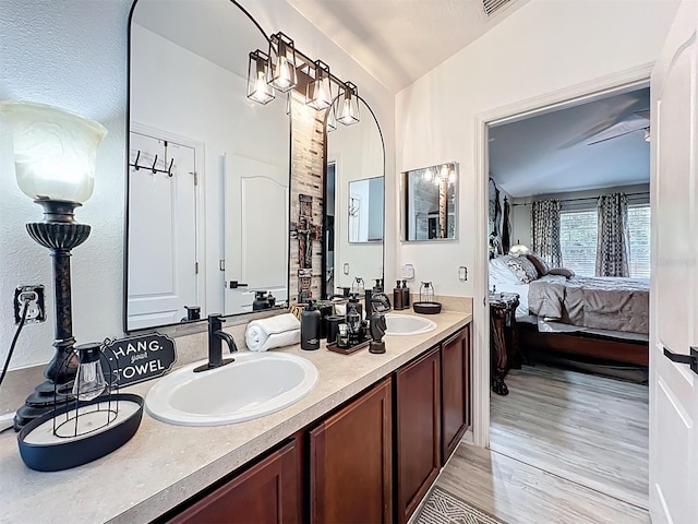 725 Ashworth Overlook Dr Unit C, Apopka, FL 32712 - ensuite bathroom with double vanity, wood finished floors, and lofted ceiling